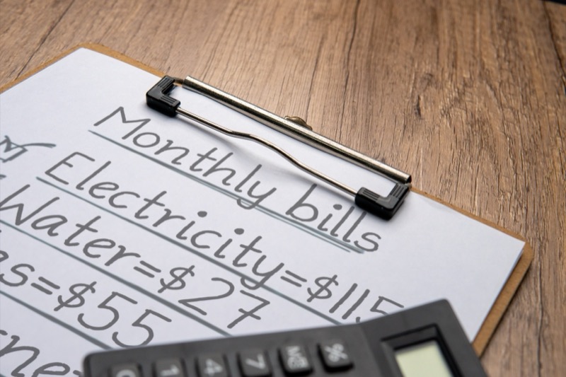 Calculator with clipboard and bills for EV charger ROI analysis