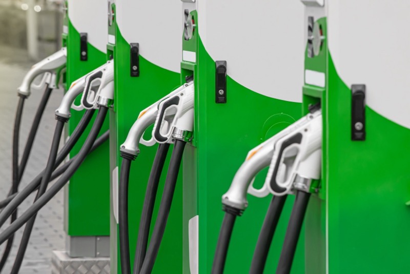 ChargePoint Home Flex EV charger installed on a garage wall next to a parked electric vehicle