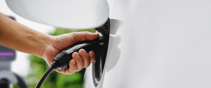 Man using an EV charging station — proper installation matters for safety and performance